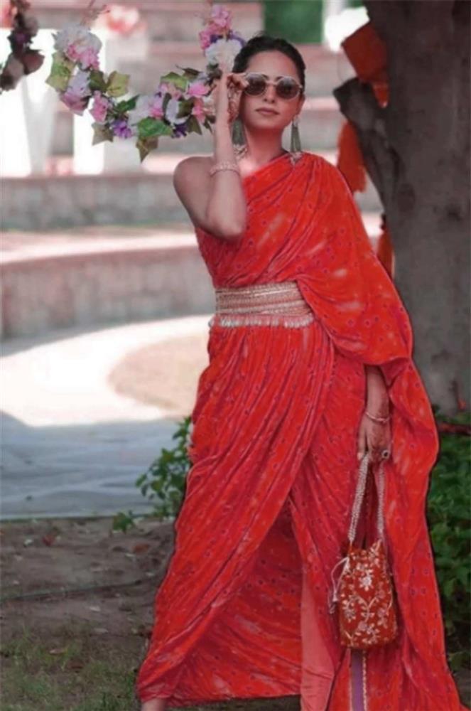 image of red saree with pant and golden belt